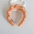 Orange plush twisted headband featuring white faux pearls on a cloud-like display stand - Orange With Pearls