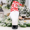Detail of red Christmas gnome wine bottle cover with knitted snowflake hat and white beard - Red Snowflake Knitted Hat