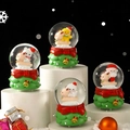 Festive Christmas snow globes with Santa and reindeer on green decorative bases - 2463# (lights + Snowflakes) / 45# (cardboard Box Packaging)