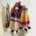Detail of mohair rainbow striped scarf with purple and white fur balls in a cozy winter setting - Rose Purple