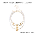 Close-up of layered necklace with white beads and golden starfish shell pendants - Whale Tail Pearl 3-Piece Set
