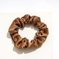 Detail of a brown satin scrunchie with silky sheen on a white stone display - Small Satin Brown