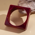 Macro detail of wine red marble texture on square acrylic chunky bangle bracelet - Rose Red