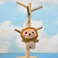 Detail view of a cute lion plush keychain hanging on a wooden stand with blue sky background - Small Lion (Silver Lobster Clasp) / 11cm