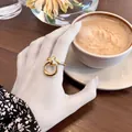 Minimalist double-loop knotted gold ring for women in an elegant cafe setting - Adjustable Open / Silver