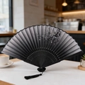 Traditional black folding fan with silver floral patterns and elegant tassel detail - Black Silver Plum