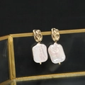 Elegant gold baroque pearl drop earrings with irregular white pearls on a black stand - Irregular Stud White Square Baroque