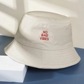 Beige canvas bucket hat with red No Bad Vibe embroidery on a minimalist background - One Size / Beige