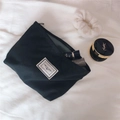 Close-up of black canvas cosmetic bag with Time to Party label and zip closure - Black