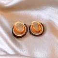 Close-up of gold double-hoop earrings with orange leopard enamel on beige silk - 16# C-shaped Gold Amber Contrast Clip