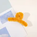 Bright yellow plush claw clip for women made of soft faux fur on a magazine background - Plush Solid Color Claw - Ginger Yellow