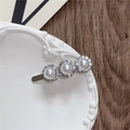 Detailed view of silver hair clip with large white pearls and rhinestone circles - Pearl Style / Silver