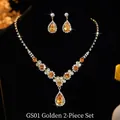 Detailed shot of golden teardrop necklace and earring set with crystals on display - GS01 Amber Zircon Set / Gold Yellow