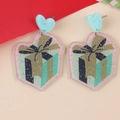 Macro view of heart-shaped acrylic earrings with pink glitter and gift box pattern - Gift Box