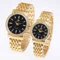 Detail shot of gold quartz couple watches with crystal bezels and black Roman dials - Women's Gold Case Black Dial
