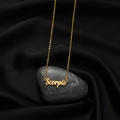 Elegant gold Scorpio zodiac pendant necklace with script lettering on black satin background - Scorpio Gold