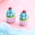 Close-up of miniature resin cupcakes with green frosting and red berries on pink wood - Double Cream Cupcake - Pink Base