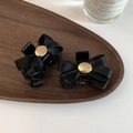 Close-up of black ribbon bow hair clips with golden engraving Believe In Your Self - Black
