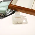 Detail view of pearl white iridescent PVC hair claw clip with square cutout design - PVC 5cm Square - Iridescent Grey