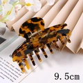 Detail showing a 9.5cm tortoiseshell acetate hair claw clip on a decorative background - 9.5CM / Glossy Tortoiseshell