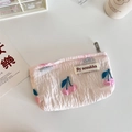 Detail showing pink floral embossed texture and cherry pattern on a mini pouch bag - Embossed Pink Cherry