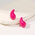 Detail of rose red teardrop earrings with a glossy finish on white stone background - Rose Red