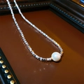 Close-up of a silver faceted bead necklace featuring a central white freshwater pearl - Necklace-Silver (Imitation Pearl)