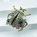 Detailed view of beetle brooch with sparkling pink crystals and faux pearl accents - Style 4-Vintage Gold Pearl Multi-color Ladybug