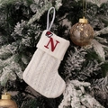 Knitted white Christmas stocking featuring red letter N embroidery and Santa hat detail - Embroidered Knitted Small Sock White N