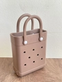 Macro detail of brown EVA beach bag showing circular perforated holes and texture - Brown