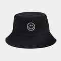 Close-up of black cotton bucket hat featuring white smiley face embroidery detail - One Size / Black