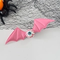 Pink bat wings Halloween hair clip with bloodshot eyeball detail and spider web accents - Pink Eyeball