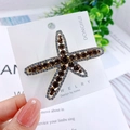 Starfish hair clip with brown rhinestones and silver alloy base on display card - Starfish Brown