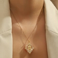 Gold Virgin Mary pendant necklace with micro-pave zircons worn on a chic beige suit - Virgin Mary Relief (YSN102GL)