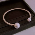 Macro view of silver coil stretch bracelet featuring large white faux pearl terminals - Silver Double Pearl Elastic Loop