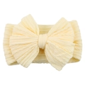 Detail showing soft yellow knit fabric texture and large bow on a baby headband - Beige
