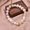 Baroque pearl bracelet with gold 18k toggle clasp on luxury silk fabric background - Elastic Baroque Freshwater Pearl Bracelet