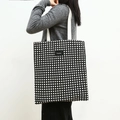 Minimalist black and white checkerboard canvas tote bag with Shopping label shown on shoulder - Black and White Grid