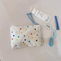 Detailed shot of white canvas pouch with colorful polka dots and light blue zipper pull - White Base Colorful Dots