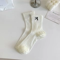 Off-white crew socks with vertical ribbing and delicate black bow embroidery detail - One Size / White
