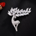 Macro shot of silver deer brooch with sparkling transparent zirconia and crystal antlers - Reindeer Brooch