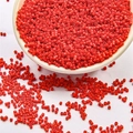 Vibrant red 2mm glass seed beads in a white bowl for DIY handmade jewelry crafts - Red
