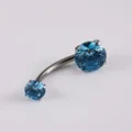 G23 titanium curved belly piercing with double prong-set round blue zirconias - 1.6*10mm / Pale Blue