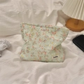 Floral canvas makeup bag on white fabric with warm ambient home decor background - Orange Floral
