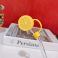 Detail of yellow lemon silicone straw topper on glass straw with dustproof cap cover - Lemon Straw Cover