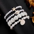 Set di 4 bracciali in stile bohémien con perle finte, conchiglie e ciondoli a stella - Set di 4 Bracciali in Perle Artificiali e Conchiglie (7820)