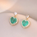 Detail of heart-shaped gold earrings with emerald green stones and zircon accents - Heart Emerald Pendant (E0778)