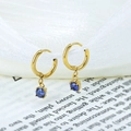 Golden round pendant earrings with round blue gemstone detail on white silk ribbon - Purple