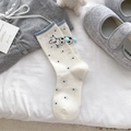 White mid-calf cotton socks with black polka dots, blue pom-poms and cartoon dog motif - Polka Dot Plush Ball Style / White Spotted Dog