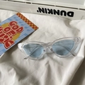 Chic cat eye sunglasses with transparent frames and light blue lenses on white fabric - Cat Eye / Transparent Frame Blue Lens